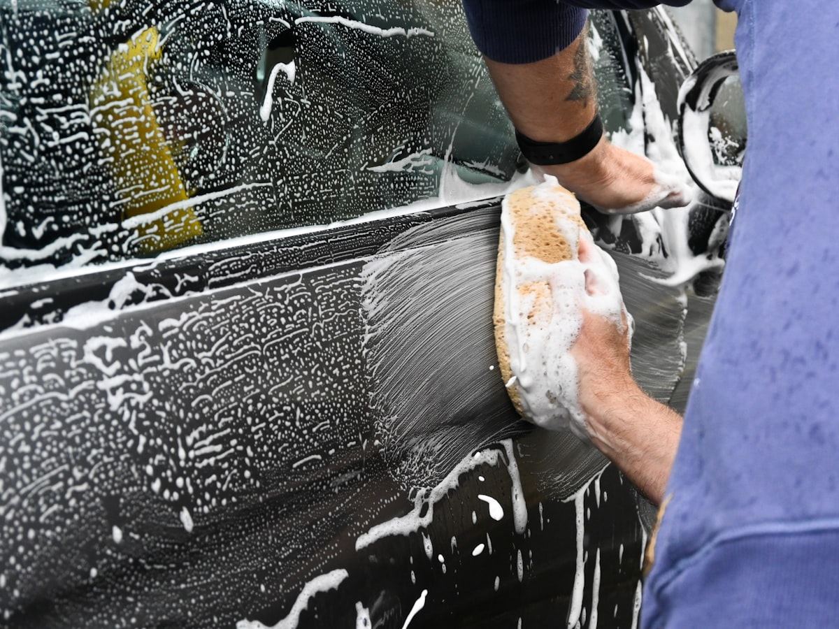 Hand washing a car with a microfibre mitt