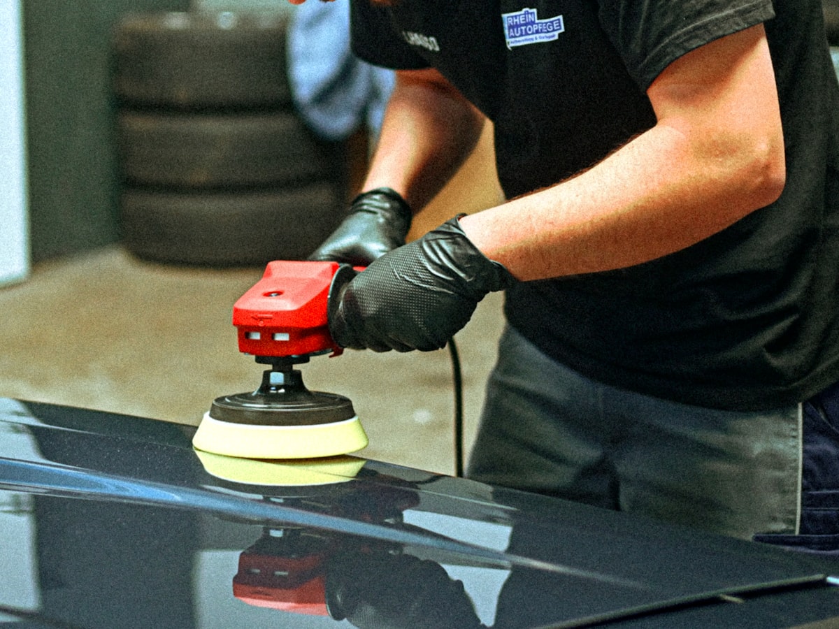 Machine polishing a car panel to restore gloss